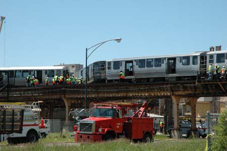 Rescue workers work at the scene where a four-car train derailed in Chicago's South Side, US, May 28, 2008. Twenty-four people were reported injured. 