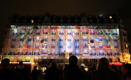  A painting drawn by French artist Pierrick Sorin is projected onto the wall of a building near the Paris East Railway Station in Paris, capital of France, on the evening of Oct. 4, 2008. The French capital on Saturday staged its annual round-the-clock culture festival, drawing at least 2 million people into the streets to enjoy the event featured by various shows of lights.