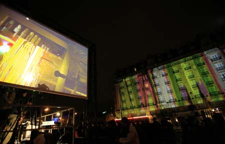 Paintings drawn by artists are projected onto the wall of a building near the Paris East Railway Station in Paris, capital of France, on the evening of Oct. 4, 2008. The French capital on Saturday staged its annual round-the-clock culture festival, drawing at least 2 million people into the streets to enjoy the event featured by various shows of lights.