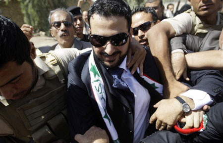 Freed shoe-thrower says he was tortured