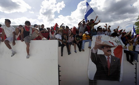 Ousted leader returns to Honduras, defies arrest