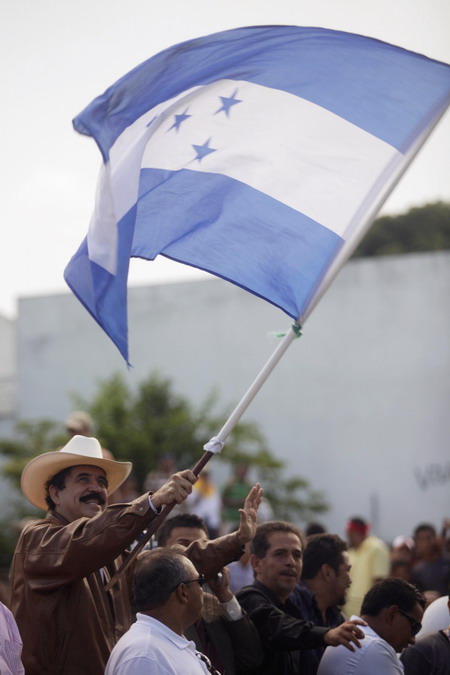 Ousted leader returns to Honduras, defies arrest