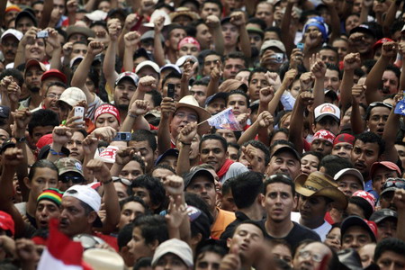Ousted leader returns to Honduras, defies arrest