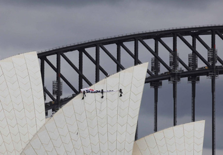 Activists climb Opera House for climate protest