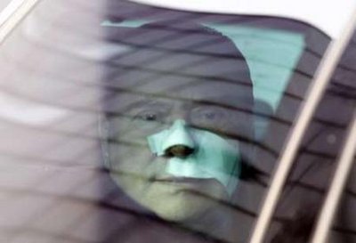 Bandaged Berlusconi leaves hospital after attack