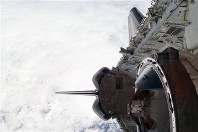 Space shuttle makes rare nighttime landing