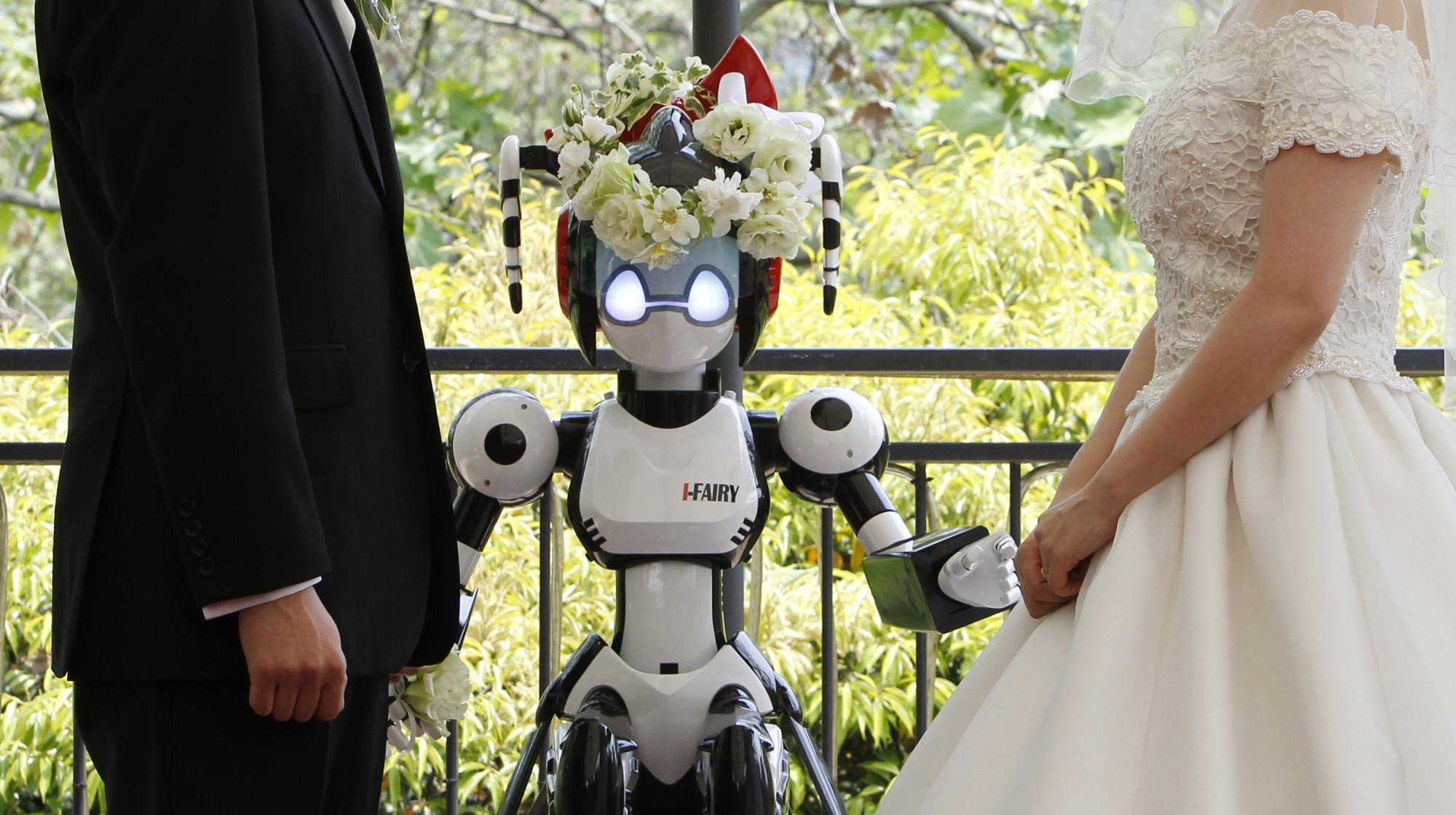 Eyes flashing, robot conducts wedding in Tokyo