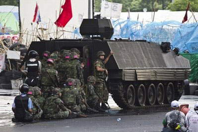 Thai army vehicles bring down protest barricade