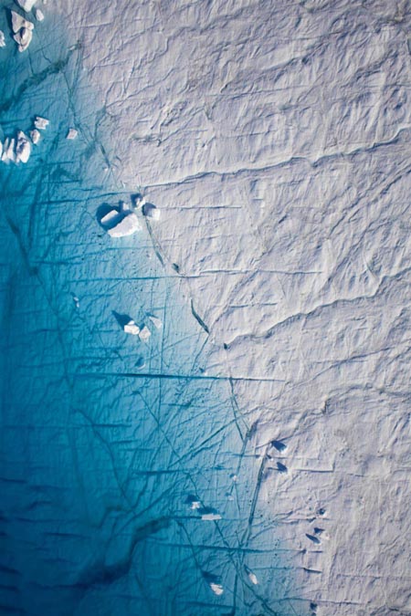 Huge ice island carves off Greenland glacier