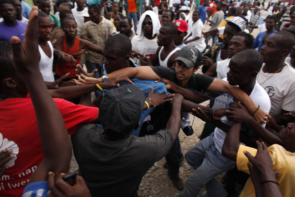 Confusion, fear as Haiti camps evacuate for storm