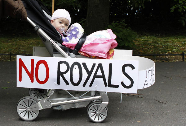 A baby stroller adorned with signs of protest against the upcoming visit of Britain's Queen Elizabeth is pushed through St Stephen's Green in Dublin May 16, 2011. Alert triggers tight security in Dublin