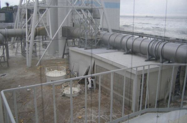 Water rushes into Tokyo Electric Power Co. (TEPCO)'s Fukushima Daiichi nuclear power plant after a tsunami triggered by an earthquake, in Fukushima, in this handout photo taken March 11, 2011, from the fourth floor of the radioactive waste disposal building, and released by TEPCO on May 19, 2011. Water rushes into Fukushima nuke power plant