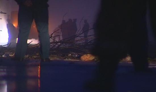 Personnel from the Russian emergency services work at the site of a plane crash about 1 km (0.6 miles) from the runway at the airport outside the northern Russian city of Petrozavodsk in this still image taken from video footage June 21, 2011. 44 killed in Russian plane crash; 8 injured