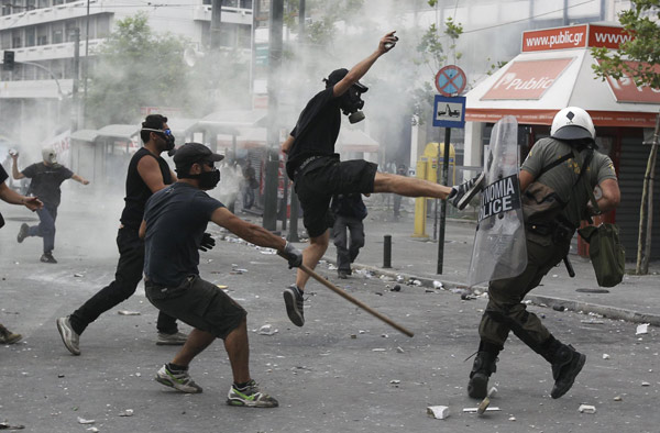 Greece passes steep cuts as riots seize capita