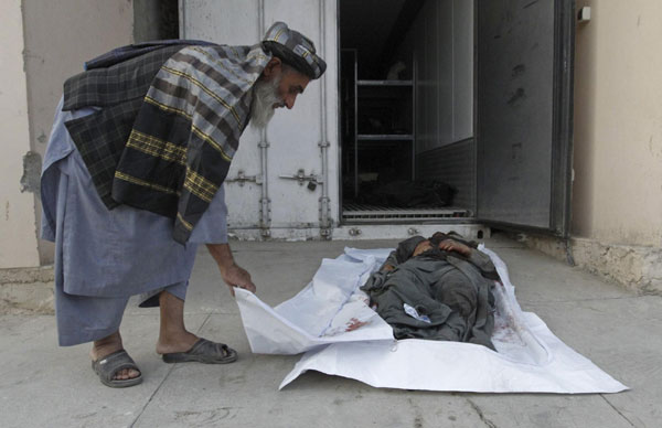 Karzai weeps as slain brother is buried