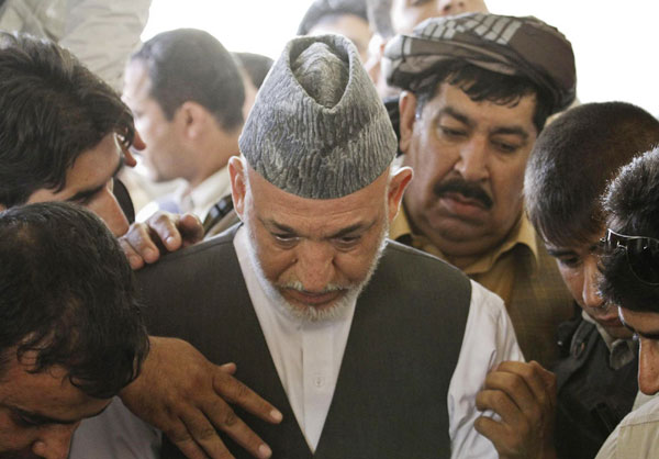 Karzai weeps as slain brother is buried