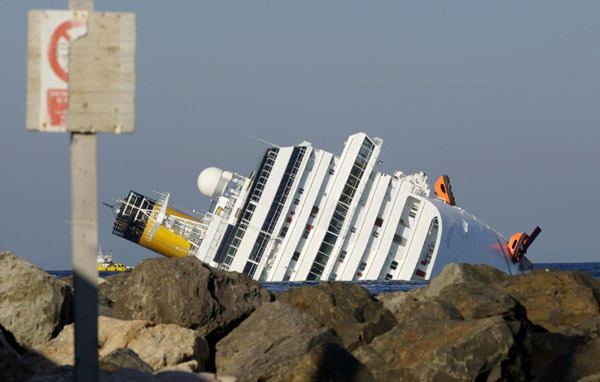 As divers search Italian cruise ship, reason for crash is unclear