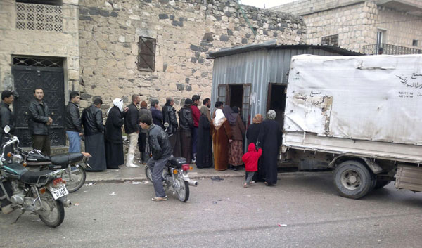 Syrians queue to buy bread in Kafranbel