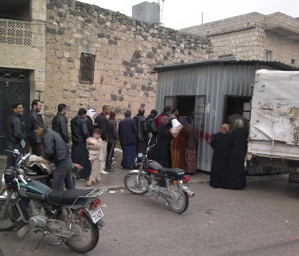 Syrians queue to buy bread in Kafranbel