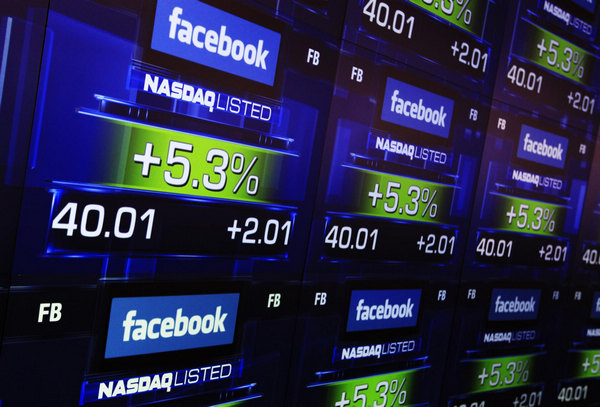 Facebook closes at $38.37 in market debut