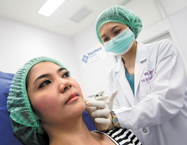 -old Thai woman, Nisakron Boonpun, gets a Botox injection at Bangkok 