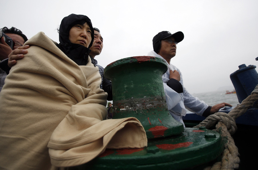 Family members of missing ferry passengers wait for words