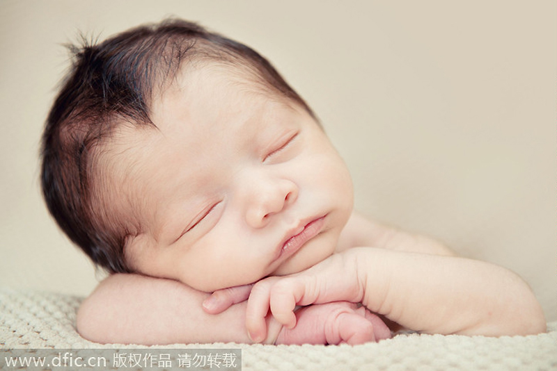 Sleeping newborns photographed in adorable poses