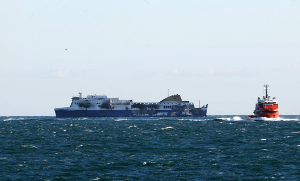 After deadly blaze, burnt-out ferry towed to Italy