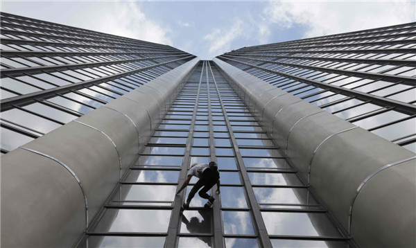 'Spiderman' climbs Paris tower in tribute to quake victims