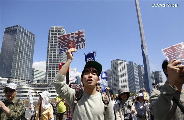 Abe's efforts to revise pacifist constitution encounter mass protest at home