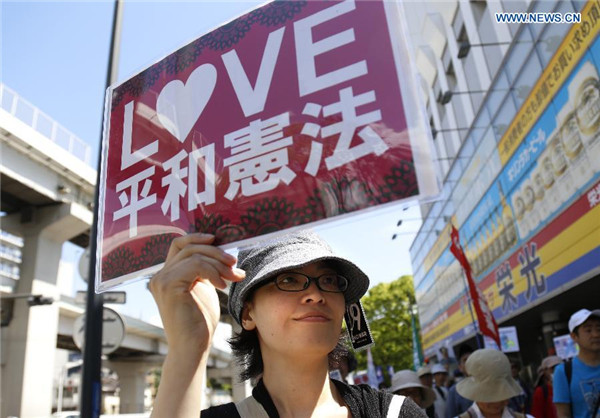 Abe's efforts to revise pacifist constitution encounter mass protest at home