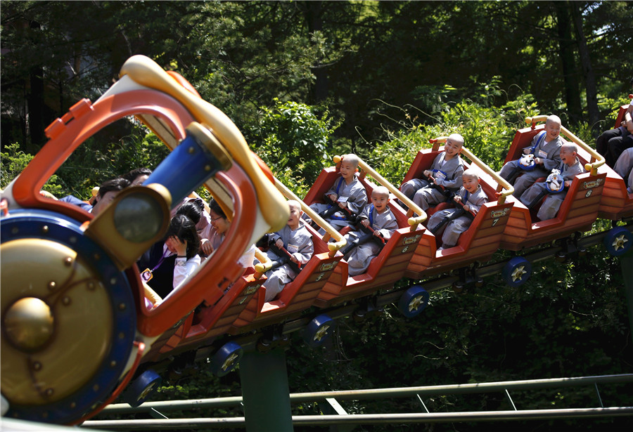 Young Buddhist monks ride on roller coaster in S. korea
