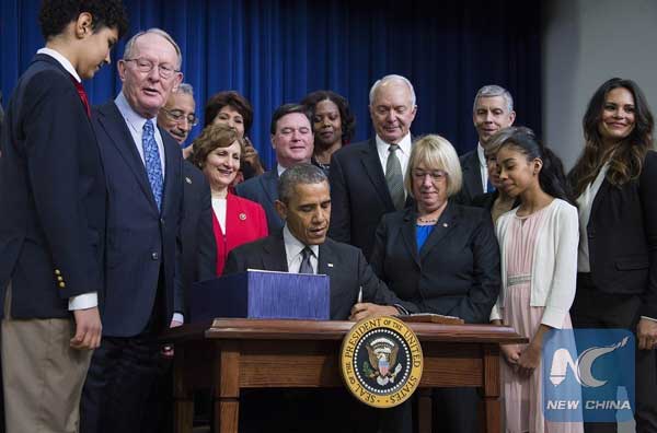 Obama signs education reform bill into law