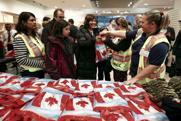 First planeload of Syrian refugees arrives in Canada