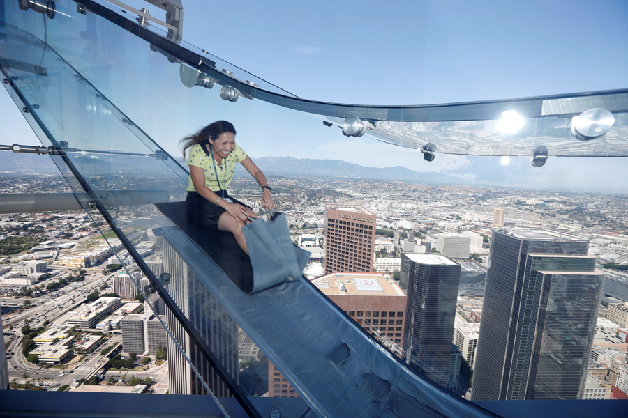 Woman rides skyslide 1000-feet above downtown Los Angeles