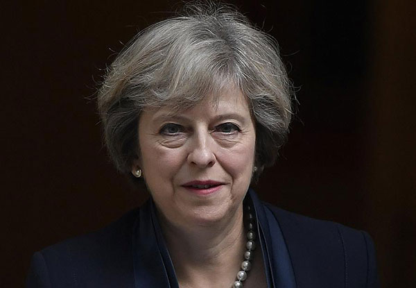 UK's Prime Minister says she'll start EU exit process by March next Year