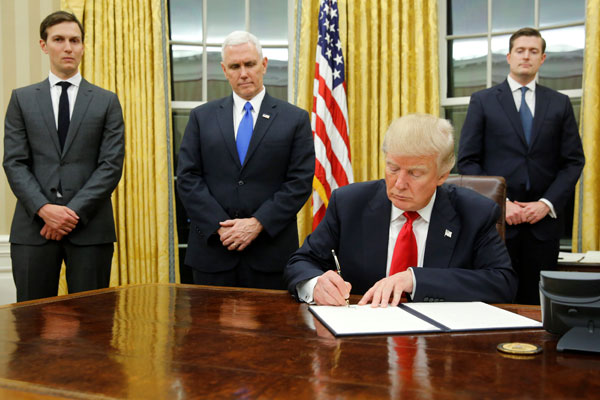 Trump signs executive order to 'ease burden' of Obamacare