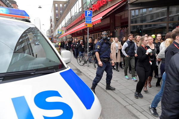 Three killed as truck drives into crowd outside Stockholm shop, shots fired