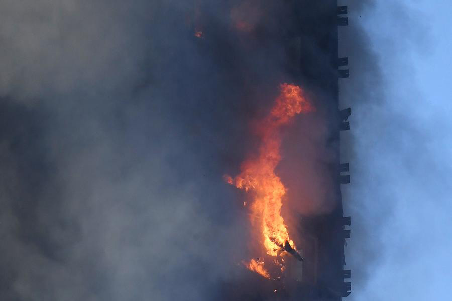 Fire engulfs London tower block, at least 12 dead