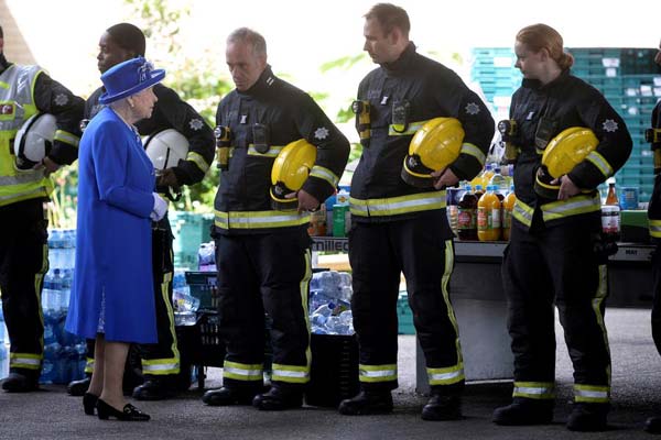 UK queen visits London fire volunteers as locals plead for answers