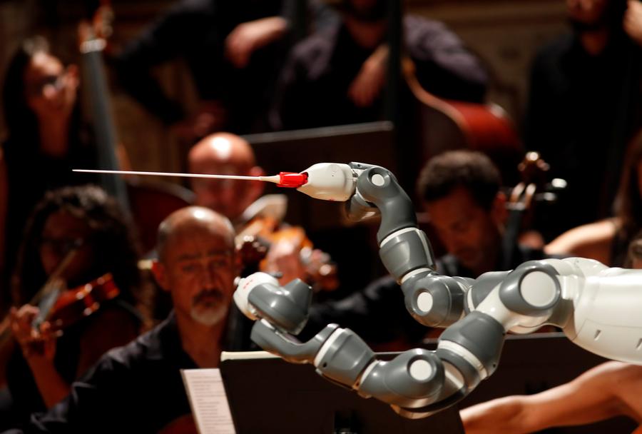 Robots conduct orchestra, play piano, read news