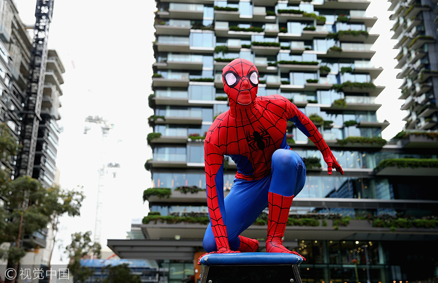 Parkour athletes dressed as spiderman scale Sydney mall