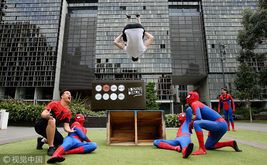 Parkour athletes dressed as spiderman scale Sydney mall