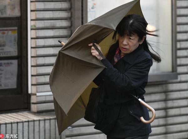 Typhoon Lan lashes central Japan, killing 2 and disrupting transport systems