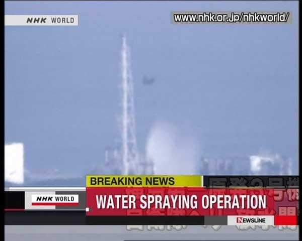 Helicopters dump water to cool reactor in Japan