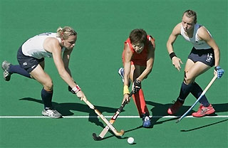 Kate Walsh, left, and Chloe Rogers, right, both from England, challenge China's Li Hua Gao during their Women's Hockey World Cup match in Madrid, Wednesday Sept. 27, 2006.