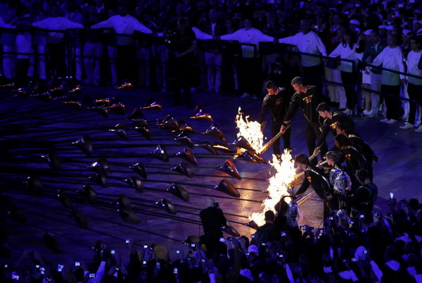 Seven teenagers light Olympic cauldron