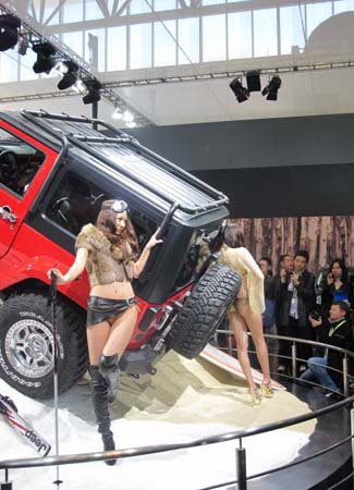 Model poses next to Jeep Wrangler