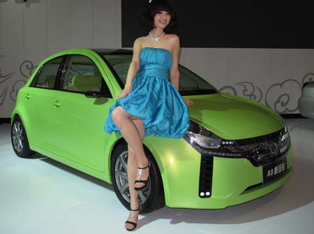 Model poses near a concept car