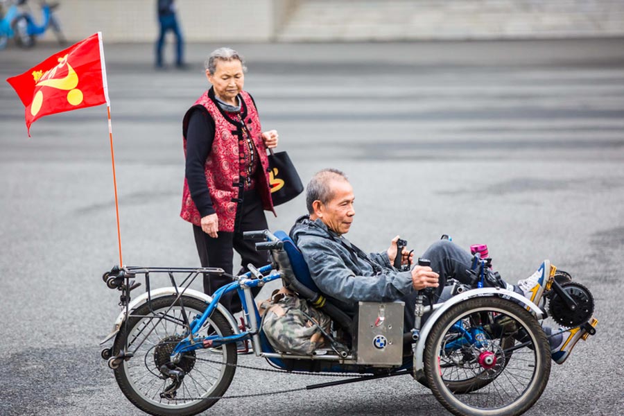 Cyclists sit back as they pedal through Guangzhou